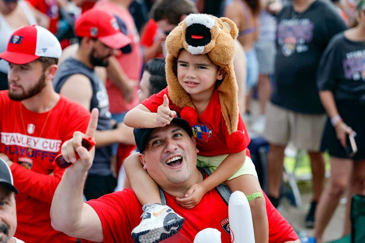Panthers fans celebrate during the Florida Panthers Stanley Cup victory parade along A1A in Fort Lauderdale, Florida on Sunday, June 30, 2024. 