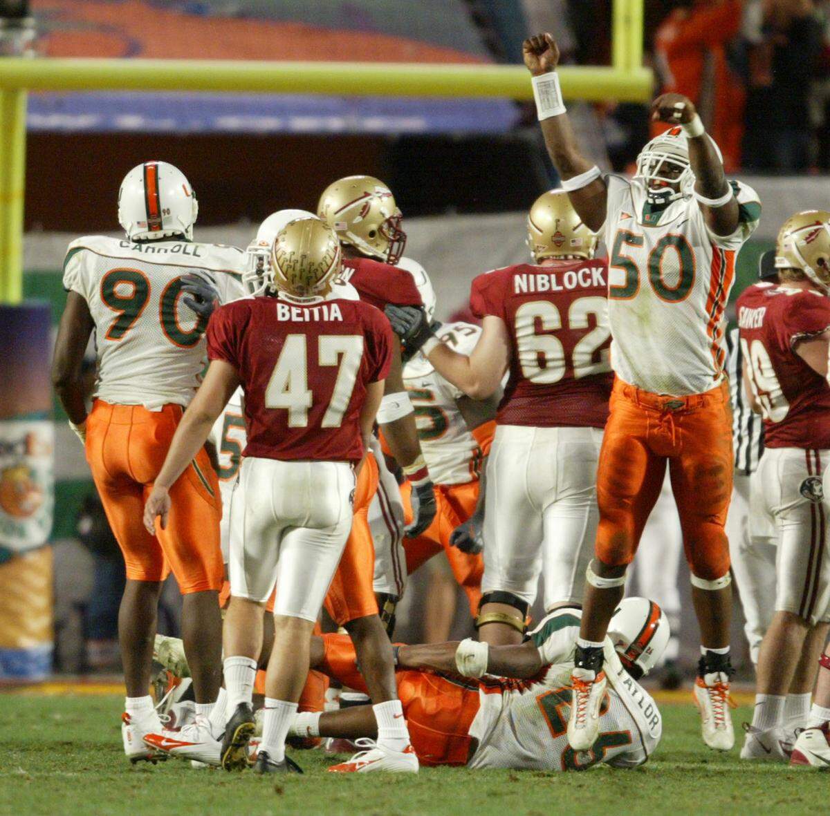 In 2004, FSU kicker Xavier Beitia watches his kick go wide right as UM’s #50 Roger McIntosh celebrates.