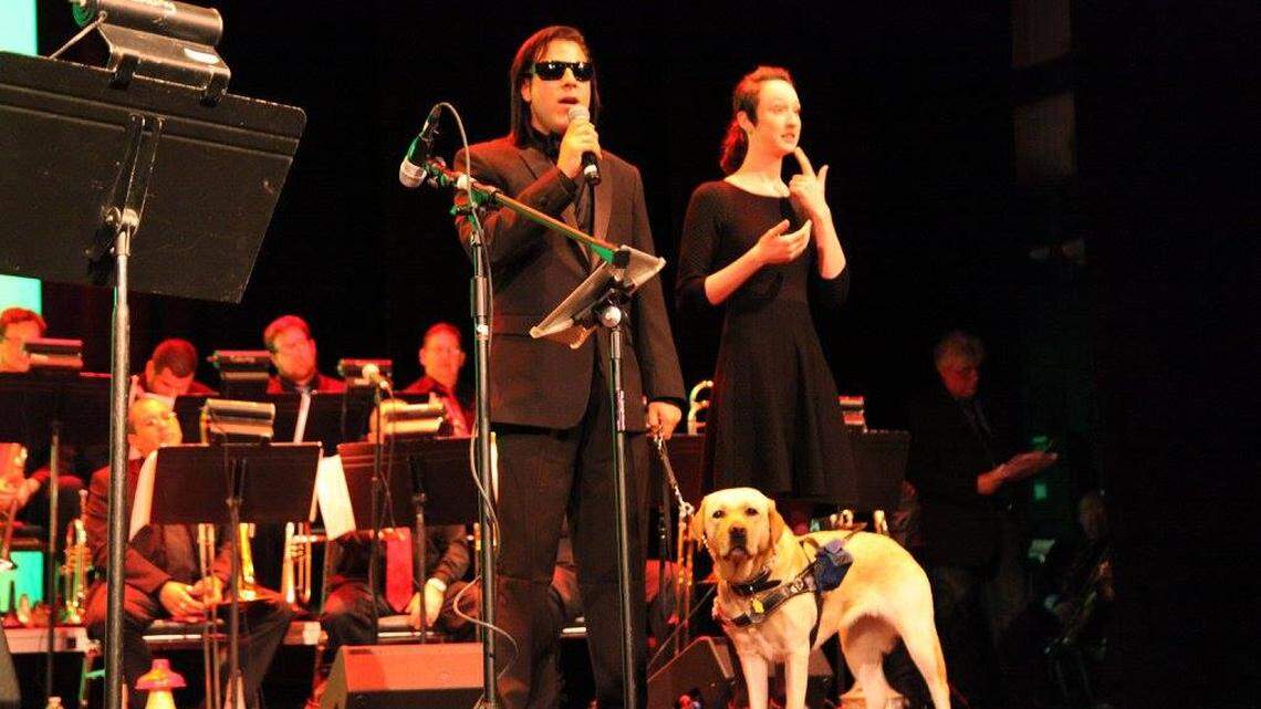 David New started the South Beach Jazz Festival to exhibit the abilities of people with disabilities. His service dog, Lola, has made a huge difference in his life. Here they are onstage at the debut festival in 2016.