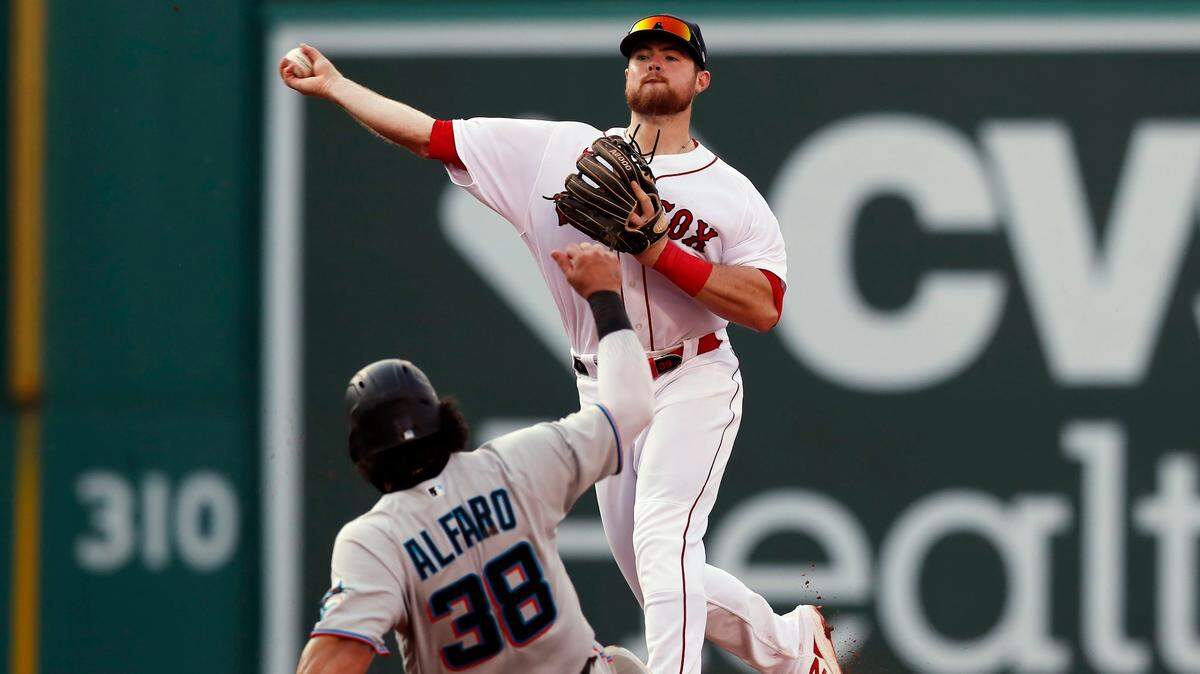 Miami Marlins’ Jorge Alfaro (38) is forced out at second base as Boston Red Sox’s Christian Arroyo, top, turns a double play against Jon Berti during the fourth inning of a baseball game, Monday, June 7, 2021, in Boston. (AP Photo/Michael Dwyer)