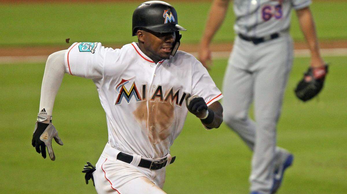 Marlins Lewis Brinson, left, sprints to first base in the bottom of the 8th inning during the Marlins against the Mets game on Sunday, July 1, 2018 at Marlins Park. 