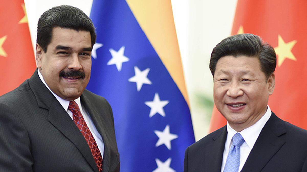 In 2015, Chinese President Xi Jinping, right, meets with Venezuelan President Nicolas Maduro in Beijing. China and Russia are seeking more influence in Latin America.