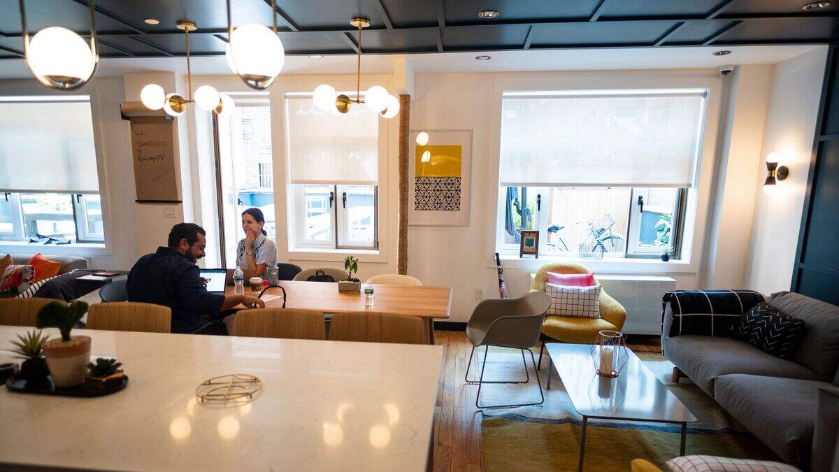Gil Hirak (R), head of US operations and community of Quarters speaks with a colleague in the community living area of Quarters Co-Living in the Lower East Side on July 24, 2019 in New York City.