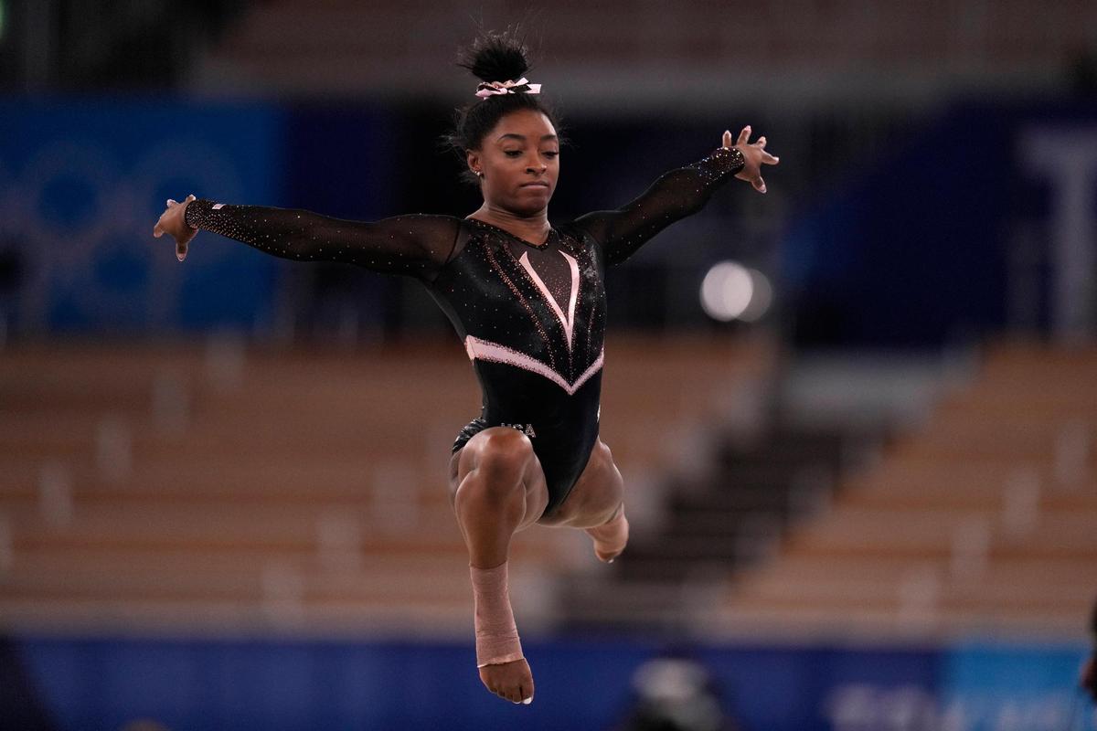 Simone Biles, of the United State, trains on the floor exercise during an artistic gymnastics practice session at the 2020 Summer Olympics, Thursday, July 22, 2021, in Tokyo, Japan. (AP Photo/Gregory Bull)