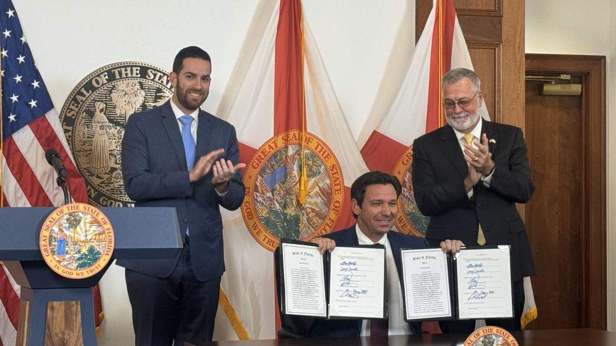 Florida Gov. Ron DeSantis, seen here between House Speaker Daniel Perez (left) and Senate President Ben Albritton (right), on Feb. 13, 2025