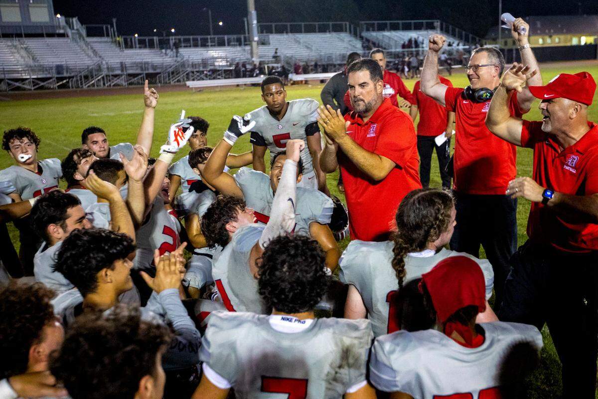 Doral Academy players and coaches react to beating Miami Southridge 46-45 in double overtime of an high school football game at South Ridge Park in Miami, Florida, on Friday, September 24, 2022.