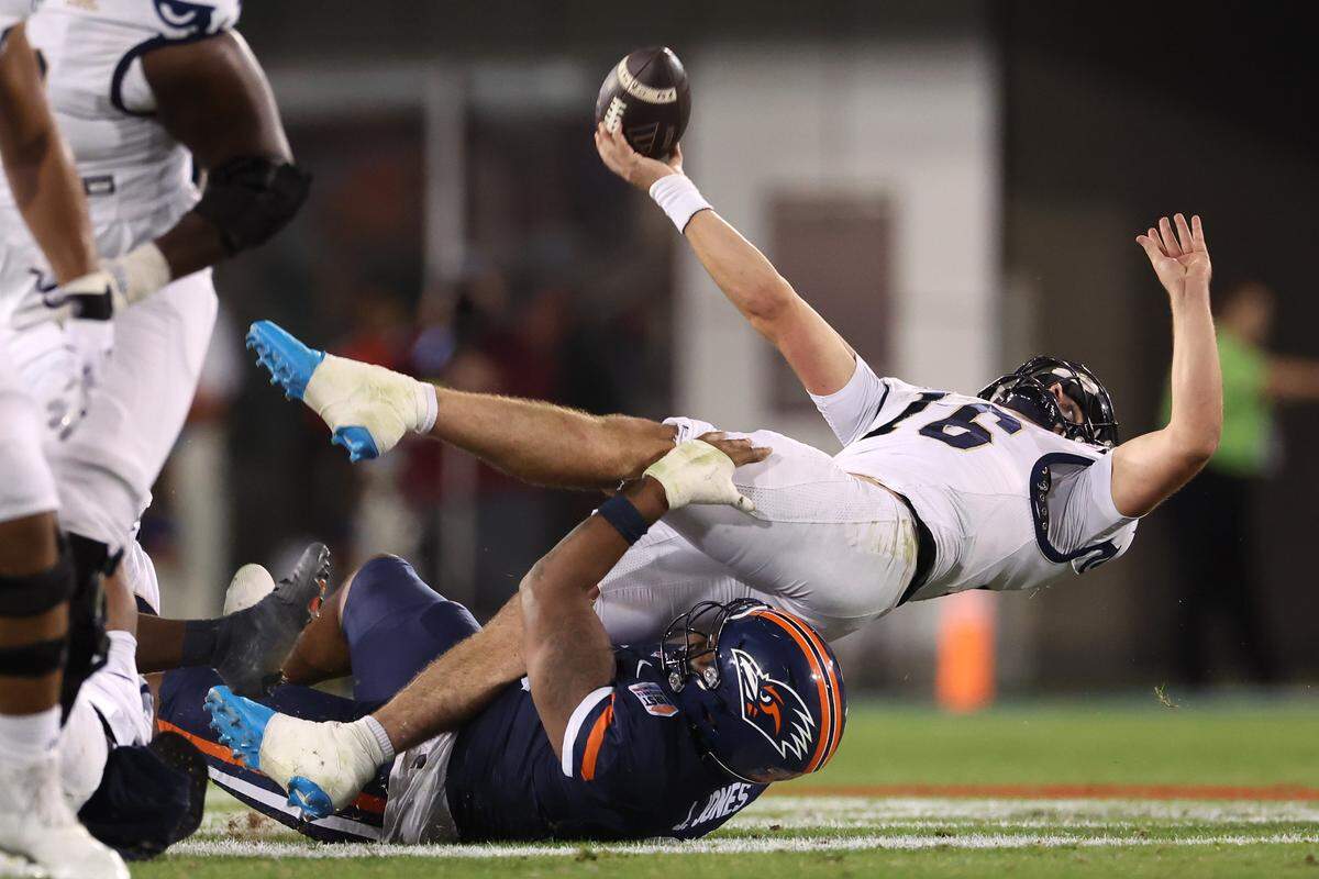 DALLAS, TEXAS - DECEMBER 26: Joe Pesansky #16 of the FIU Panthers is tackled by Jonathan Jones #35 of the UTSA Roadrunners during the second quarter in the 2025 SERVPRO First Responder Bowl at Gerald J. Ford Stadium on December 26, 2025 in Dallas, Texas. (Photo by Sam Hodde/Getty Images)