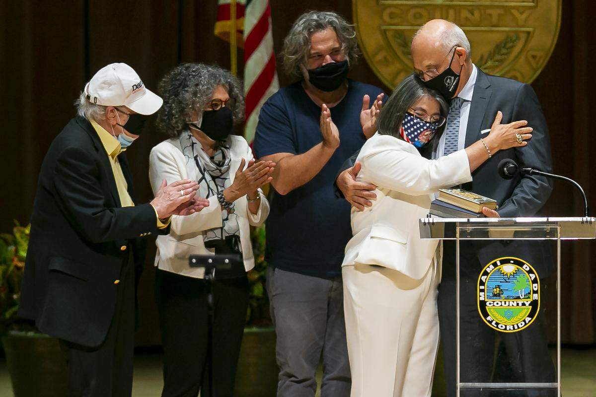 Newly elected Miami-Dade Mayor Daniella Levine Cava, center, is congratulated by her family after being sworn into office by Judge Roy K. Altman inside the Knight Concert Hall at the Adrienne Arsht Center for the Performing Arts in downtown Miami on Tuesday, Nov. 17, 2020.