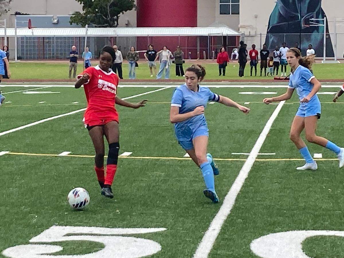 Edison’s Shnidine Marcialus battles for possession with Ransom defenders during Friday’s Region 4-3A girls’ soccer semifinal victory at Miami Edison.