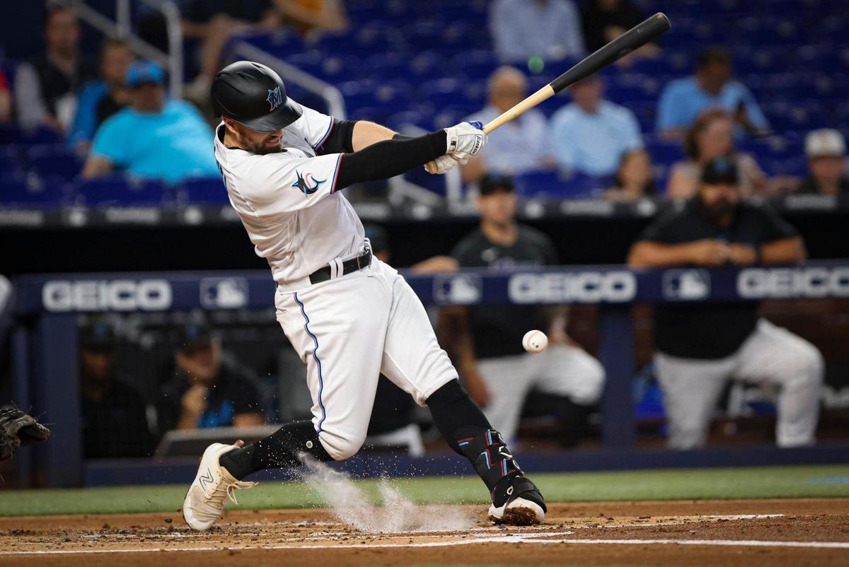 Miami Marlins third baseman Jon Berti (5) hits a grounder during the second inning of an MLB game on Wednesday, April 19, 2023, at loanDepot Park in Miami.