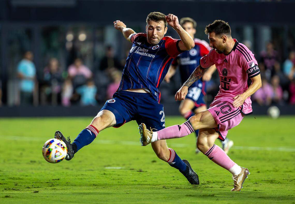Inter Miami forward Lionel Messi (10) scores a goal as New England Revolution defender Dave Romney (2) defends in second half of their MLS match at Chase Stadium on Saturday, Oct. 19, 2024, in Fort Lauderdale, Fla.