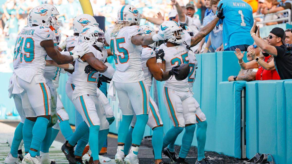 Miami Dolphins cornerback Xavien Howard (25) celebrate with teammates after an interception against the Carolina Panthers during the second quarter of an NFL football game at Hard Rock Stadium on Sunday, November 28, 2021 in Miami Gardens, Florida.