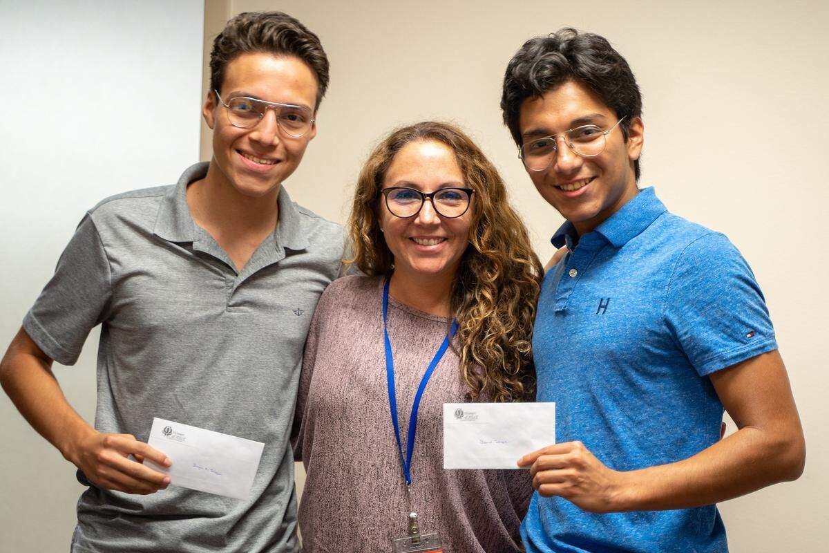 The Florida chapter of Women of AT&T recently awarded several scholarships to former Miami-Dade County high school students. Pictured above are scholarship recipients Daniel Torrejon, left, and Diego Torrejon, right, with their mother, Graciela Villalobos.