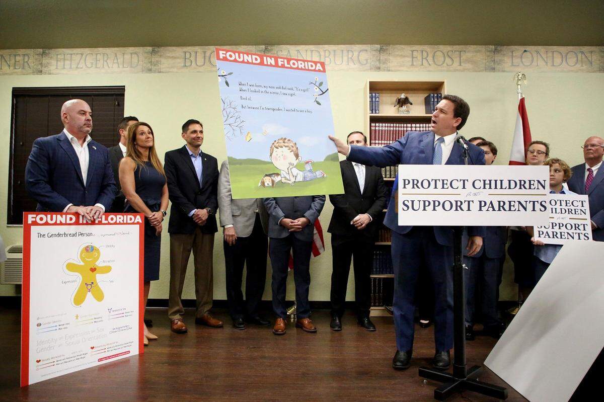 Florida Gov. Ron DeSantis shows an image from the children’s book “Call Me Max” by transgender author Kyle Lukoff moments before signing the Parental Rights in Education bill during a news conference on Monday, March 28, 2022, at Classical Preparatory school in Shady Hills. At left is an image of “The Genderbread Person,” a teaching tool used for breaking the concept of gender.