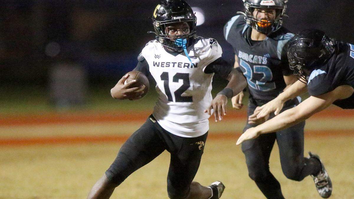Western Wildcats Sherrod Gourdine (12) carries the ball against the West Broward Bobcats during football game on Friday, November 1, 2024 at Everglades HS in Miramar.