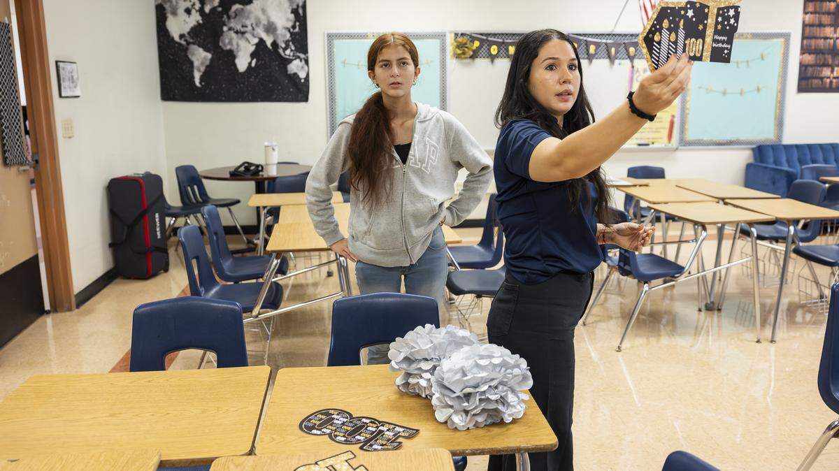 Eighth grader Jenny Lopez, 13, helps her speech and debate teacher, Stephanie Campos, decorate her classroom as they prepare for the first day of school at Ponce de Leon Middle School on Wednesday, Aug. 13, 2025, in Coral Gables, Fla. Campos, who teaches theater alongside speech and debate, is entering her ninth year of teaching.