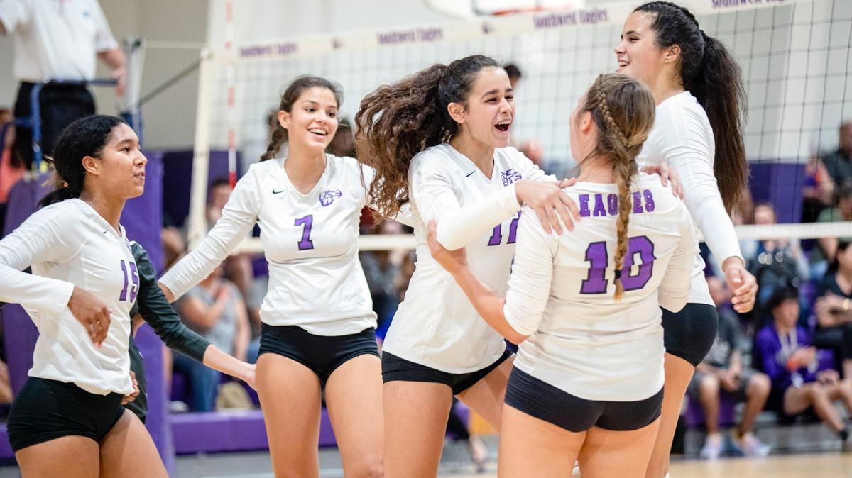 Southwest Miami Senior High School girls volleyball team celebrates after scoring against the Ferguson girls volleyball team during a match at Southwest Miami Senior High School Gym in Miami, Florida, on Tuesday, October 29, 2019.