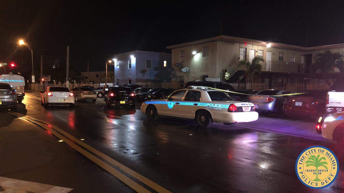 Police vehicles are seen outside an apartment building at Northwest 66th Street and 12th Avenue early Tuesday morning.  A 5-year-old girl was hospitalized after being shot in the back.