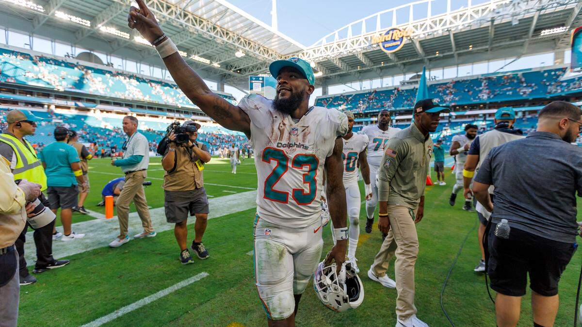 Miami Dolphins running back Jeff Wilson Jr. (23) greets fans after their 39-17 win over the Cleveland Browns during an NFL football game at Hard Rock Stadium on Sunday, November 13, 2022 in Miami Gardens, Florida.