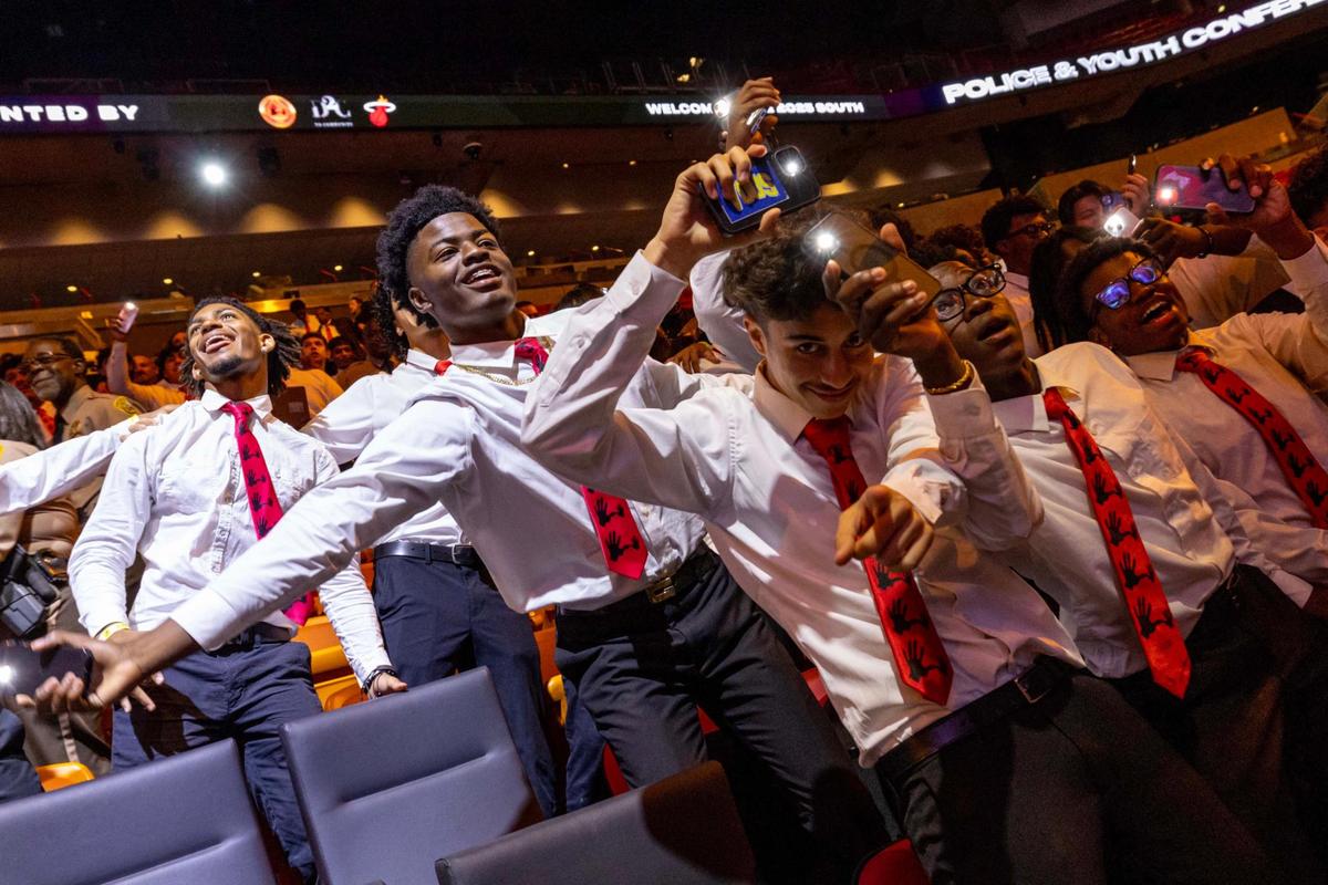 5,000 Role Models members swag surf during a 5000 Role Models Police & Youth Conference hosted by the Miami Heat and Dedication 2 Community at Kaseya Center.