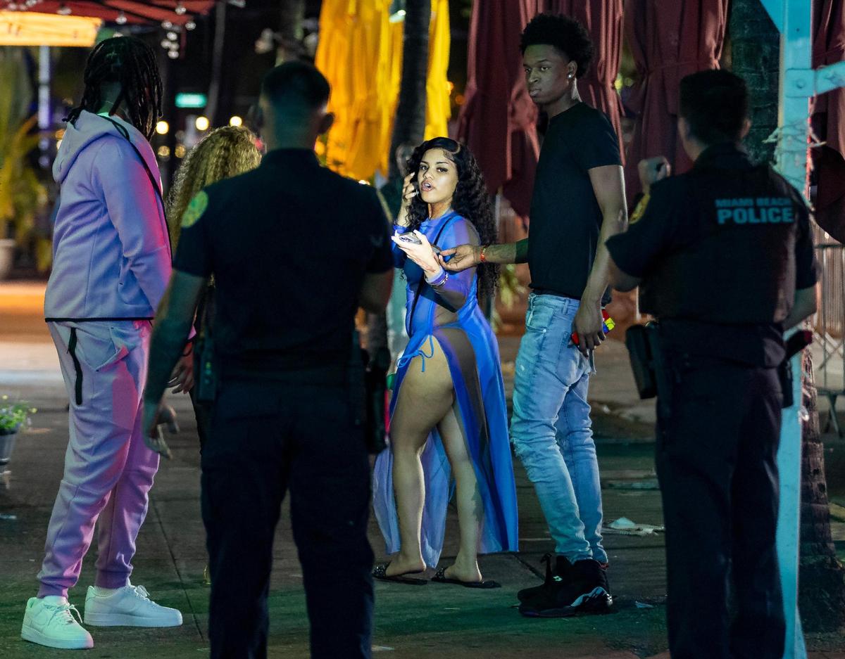 Police officers enforce a midnight curfew near Mango’s Tropical Cafe on Ocean Drive during spring break on Friday, March 15, 2024, in Miami Beach.