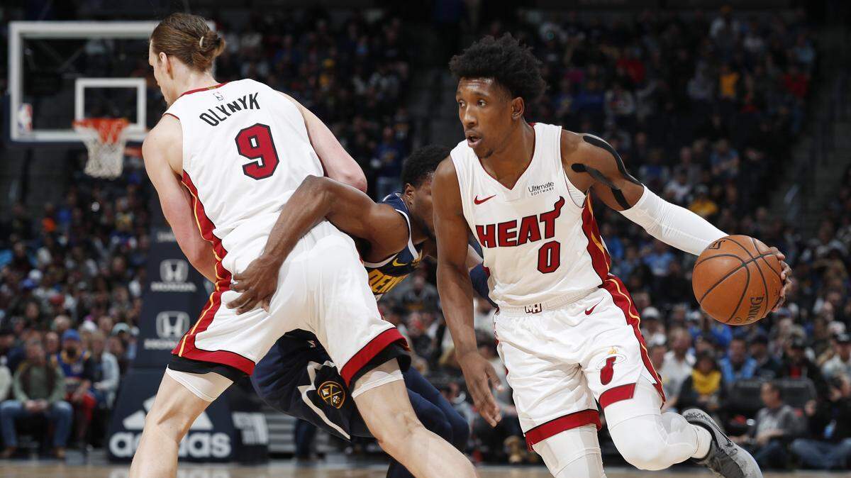 From left, Miami Heat forward Kelly Olynyk sets a pick on Denver Nuggets guard Malik Beasley and allows Miami guard Josh Richardson to drive to the net in the first half of an NBA basketball game Monday, Feb. 11, 2019, in Denver. (AP Photo/David Zalubowski)