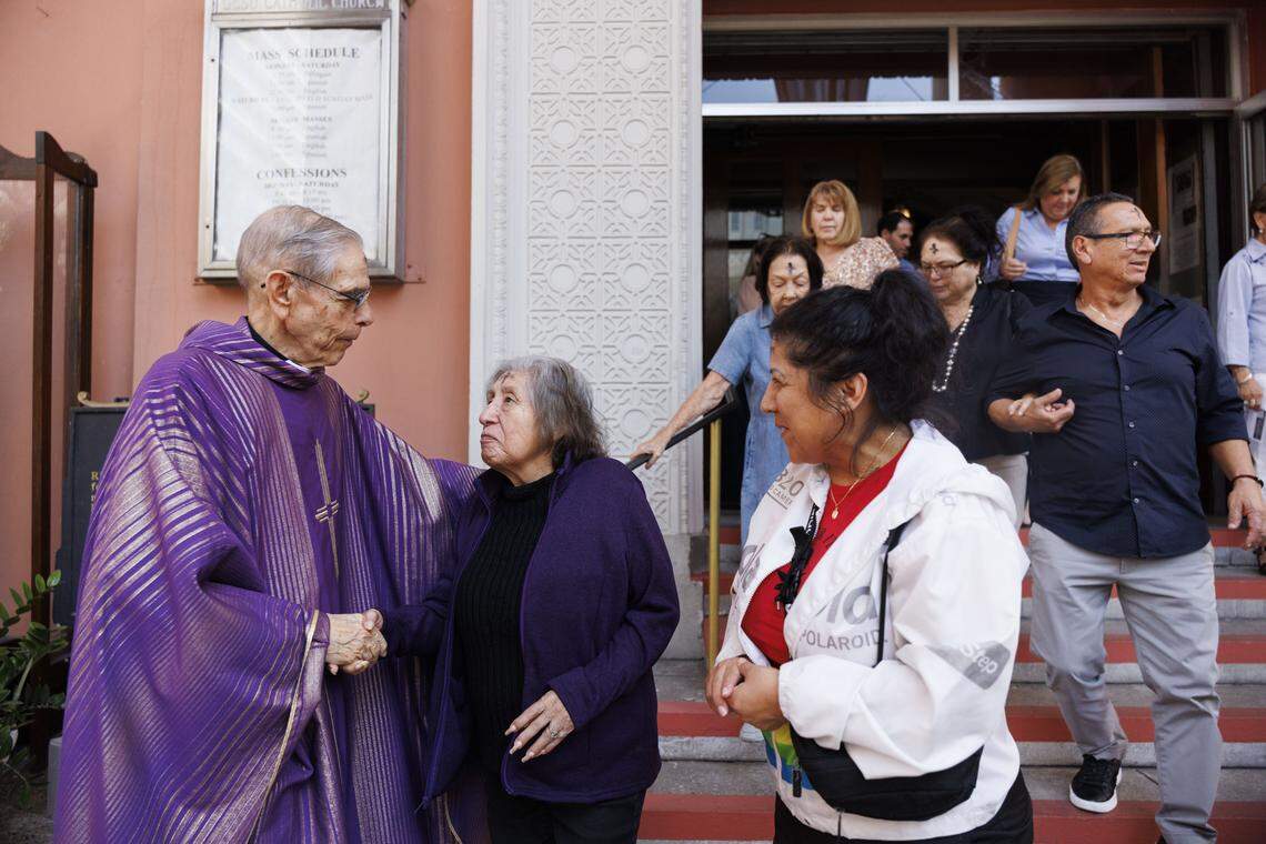 Fr. Javier López, left, greets parishioners after Ash Wednesday mass on Wednesday, Feb. 18, 2026, at Gesu Catholic Church in downtown Miami.  