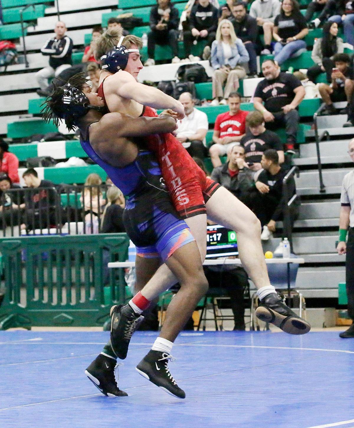 South Dade Tyree Graham lifts Miami Beach Senior Adlan Dzhabrailov during 2025 GMAC 157 lb weight wrestling final match on Saturday, February 8, 2025 at Miami Central HS in Miami. Andrew Uloza / for Miami Herald