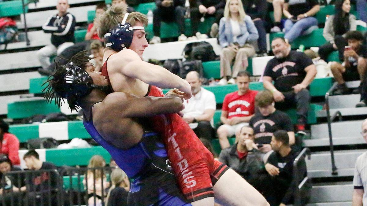 South Dade’s Tyree Graham lifts Miami Beach’s Adlan Dzhabrailov during the GMAC wrestling 157 pounds final match on Saturday, February 8, 2025 at Miami Central HS in Miami. 