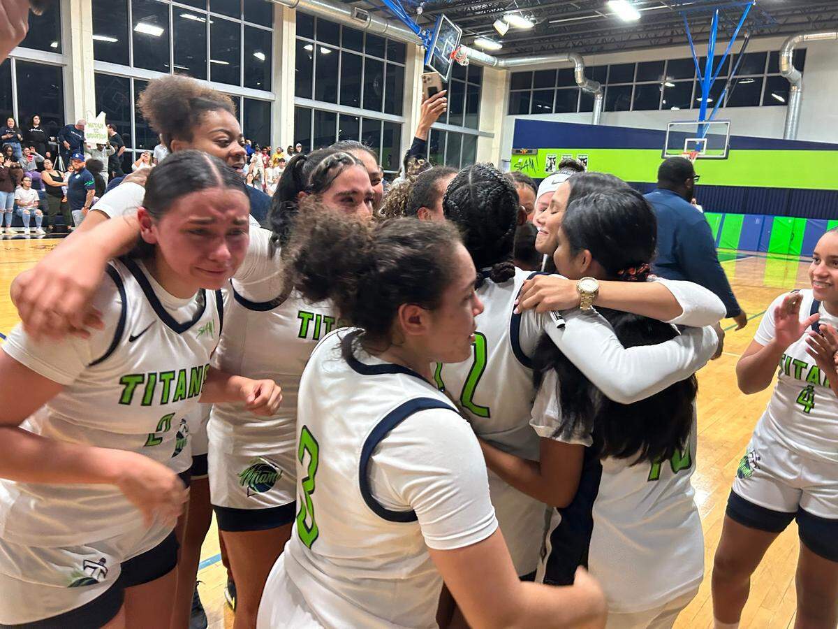 SLAM players let out their emotions after winning the Region 4-4A girls’ basketball championship on Thursday night at the SLAM gym.