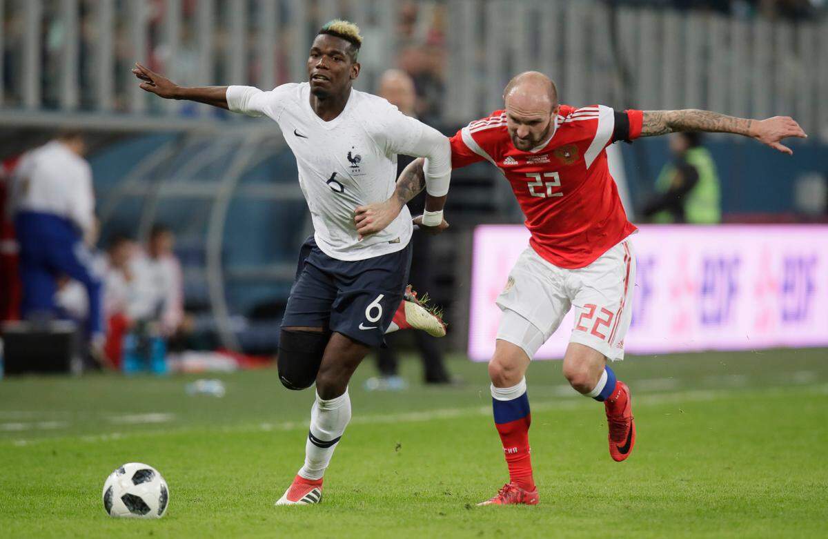 FILE - In this Tuesday, March 27, 2018 file photo, Russia's Konstantin Rausch, right, duels for the ball with France's Paul Pogba during the international friendly soccer match between Russia and France at the Saint Petersburg stadium in St.Petersburg, Russia. (AP Photo/Dmitri Lovetsky, File)