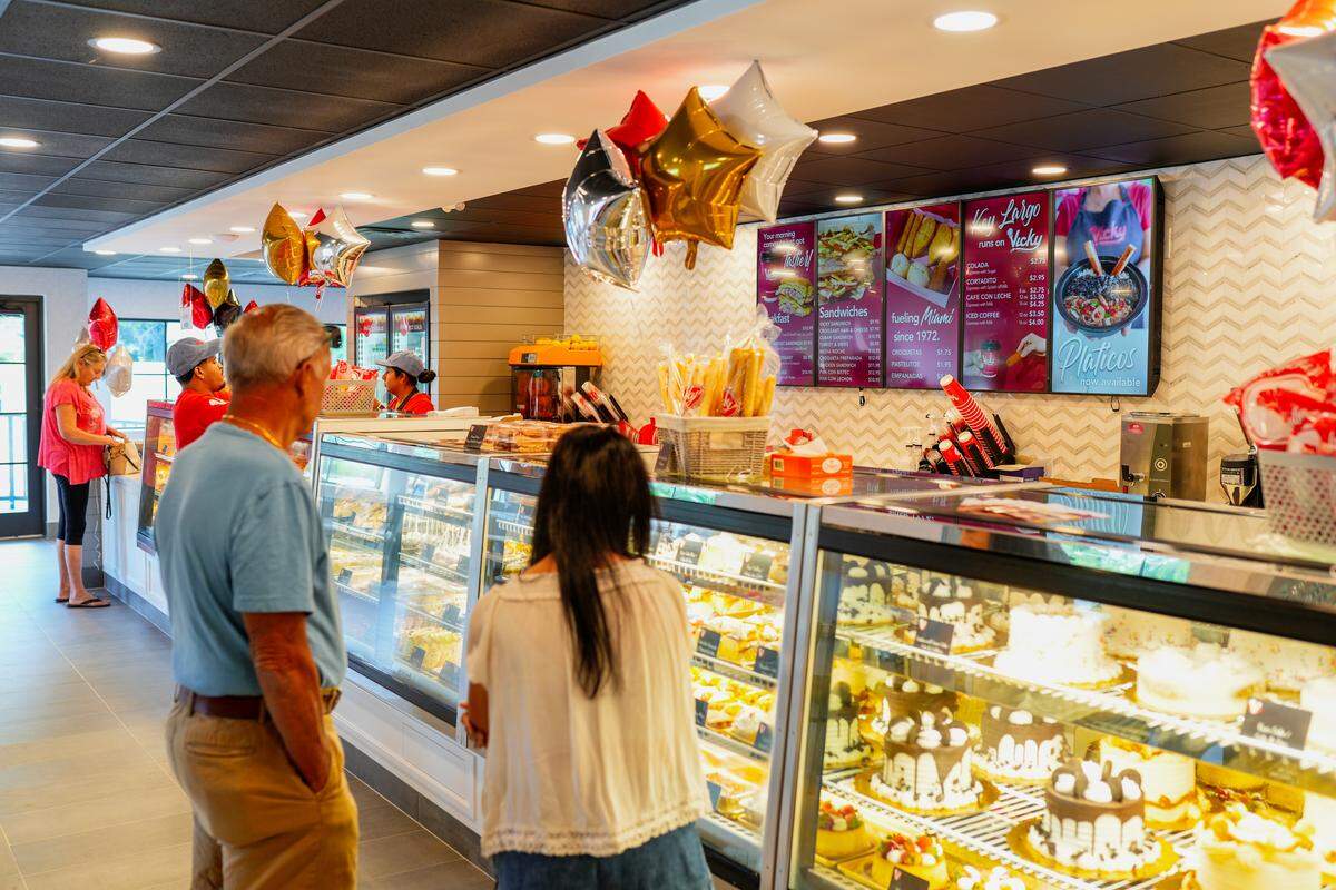 Customers eye the cakes and desserts at Vicky Bakery.