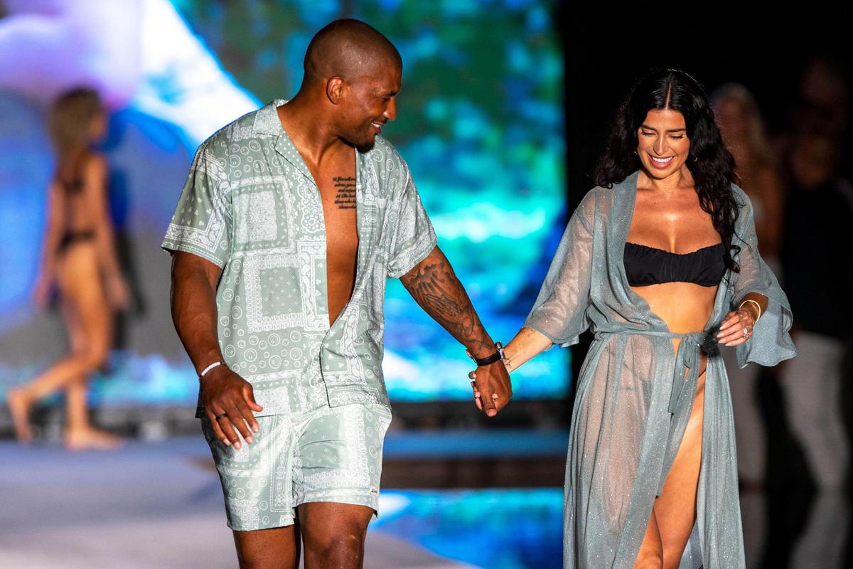 Larry English and Nicole Williams English walk the runway during the 2022 Sports Illustrated Swimsuit Runway Show at W South Beach beachfront pool in Miami Beach, Florida, on Saturday, July 16, 2022.