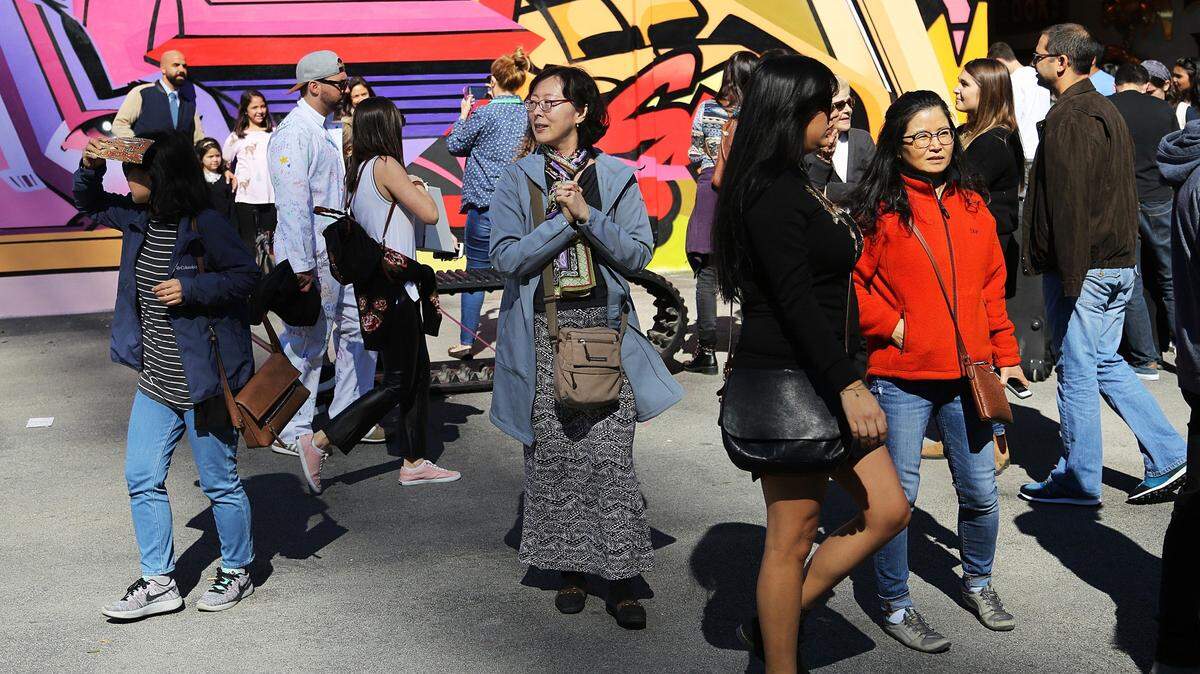 Tourists and locals gather at Wynwood Walls. Wynwood, a former industrial district, is now a center for art, restaurants, bars, offices and residential units.