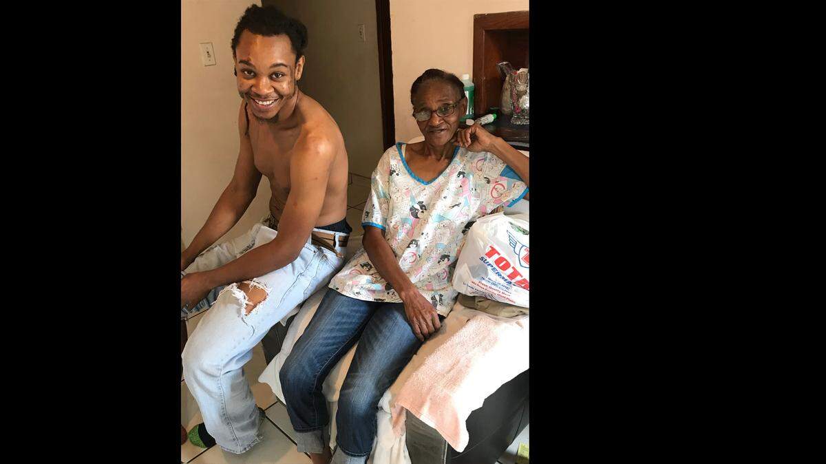 While Pherrick Thomas Jr., 26, left, tried to wrestle away a weapon from a man who had intruded on his home, his grandmother June Green, 65, right, picked up a rock and smashed the would-be-robber in the face.
