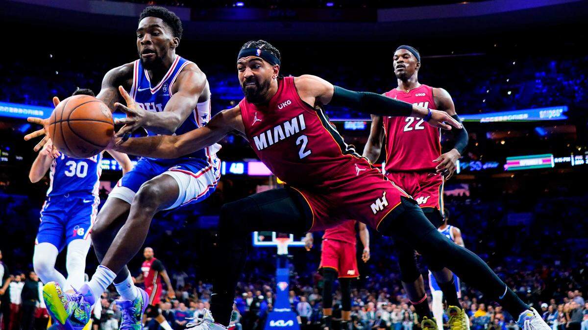 Philadelphia 76ers’ Shake Milton, left, and Miami Heat’s Gabe Vincent battle for the ball during the first half of Game 3 of an NBA basketball second-round playoff series, Friday, May 6, 2022, in Philadelphia.