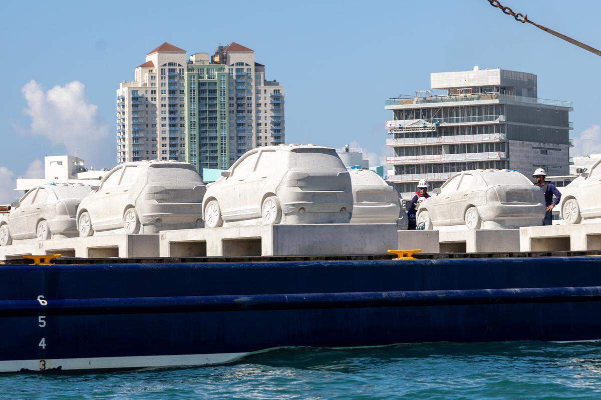 Concrete cars loaded up on the barge off the shore of Miami Beach.