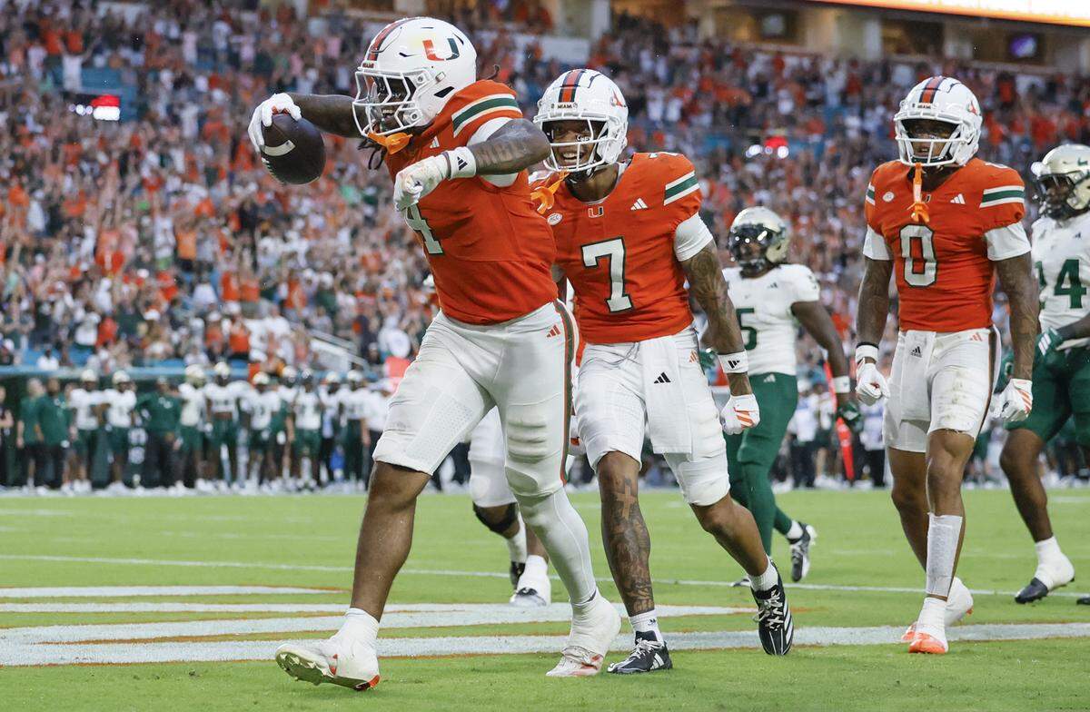 Miami Hurricanes running back Mark Fletcher Jr. (4) reacts after scoring in the first half of their NCAA football game against the South Florida Bulls at Hard Rock Stadium in Miami Gardens, Florida, on Saturday, September 13, 2025.