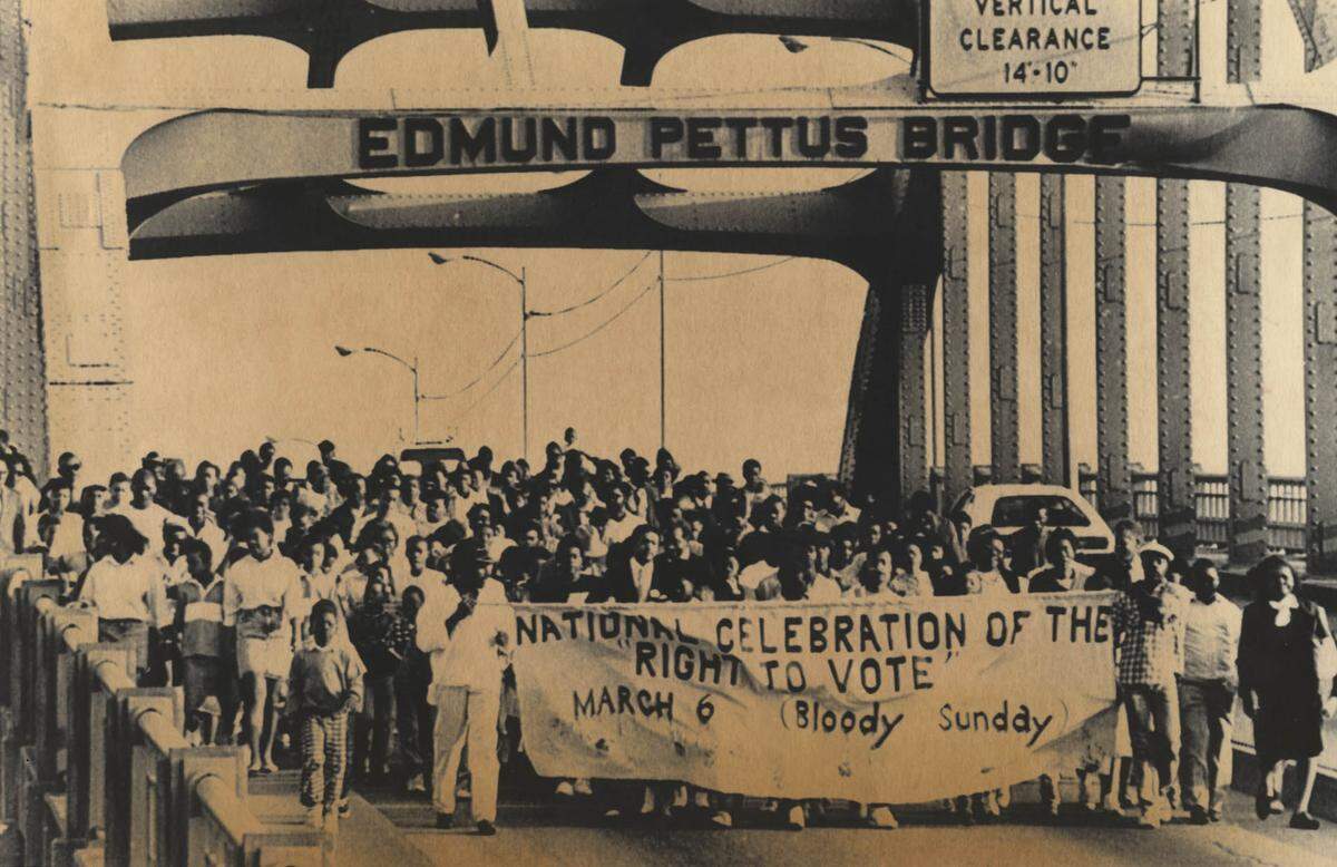 Civil rights activists march across the Edmund Pettus Bridge in Selma, Ala., on March 18, 2001 to mark the 23rd anniversary of “Bloody Sunday,” when state troopers beat dozens of marchers attempting to cross the bridge.