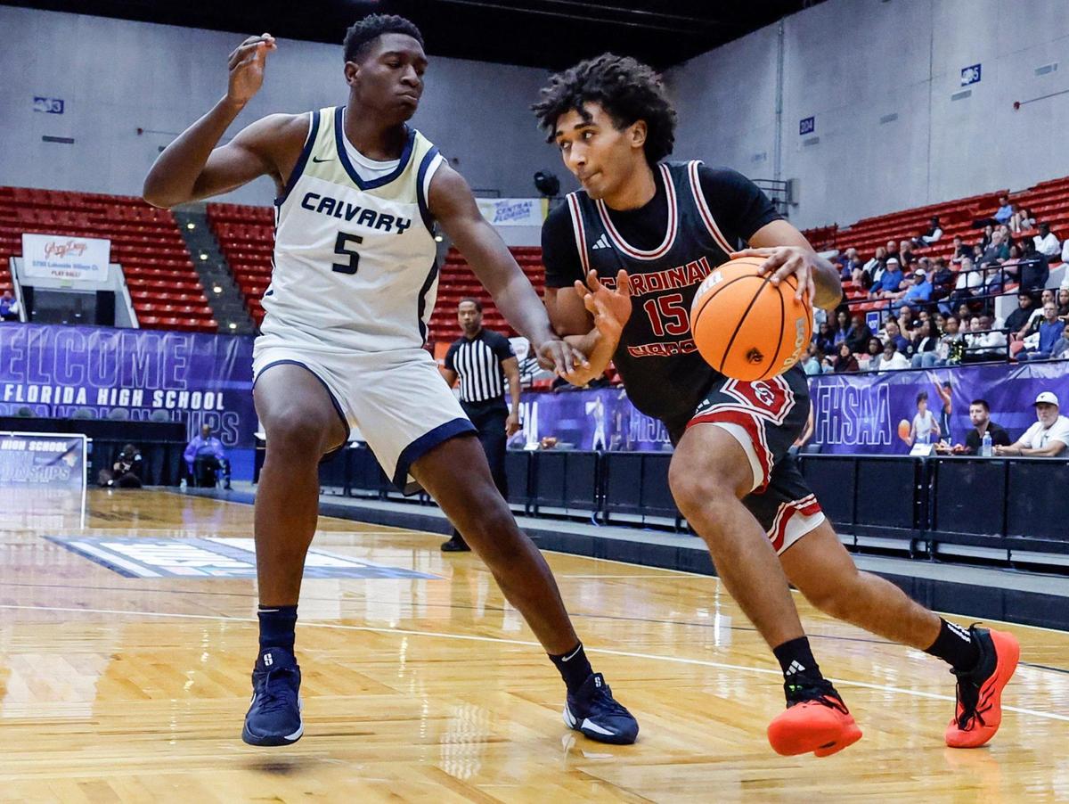 Cardinal Gibbons Marcus Perrier (15) drives the ball as Calvary Christian Academy’s KJ Ambrose (5) defends in the second half during boys 3A basketball semifinal game of the Florida High School State Championships at the RP Funding Center in Lakeland, Florida on Friday, February 28, 2025.