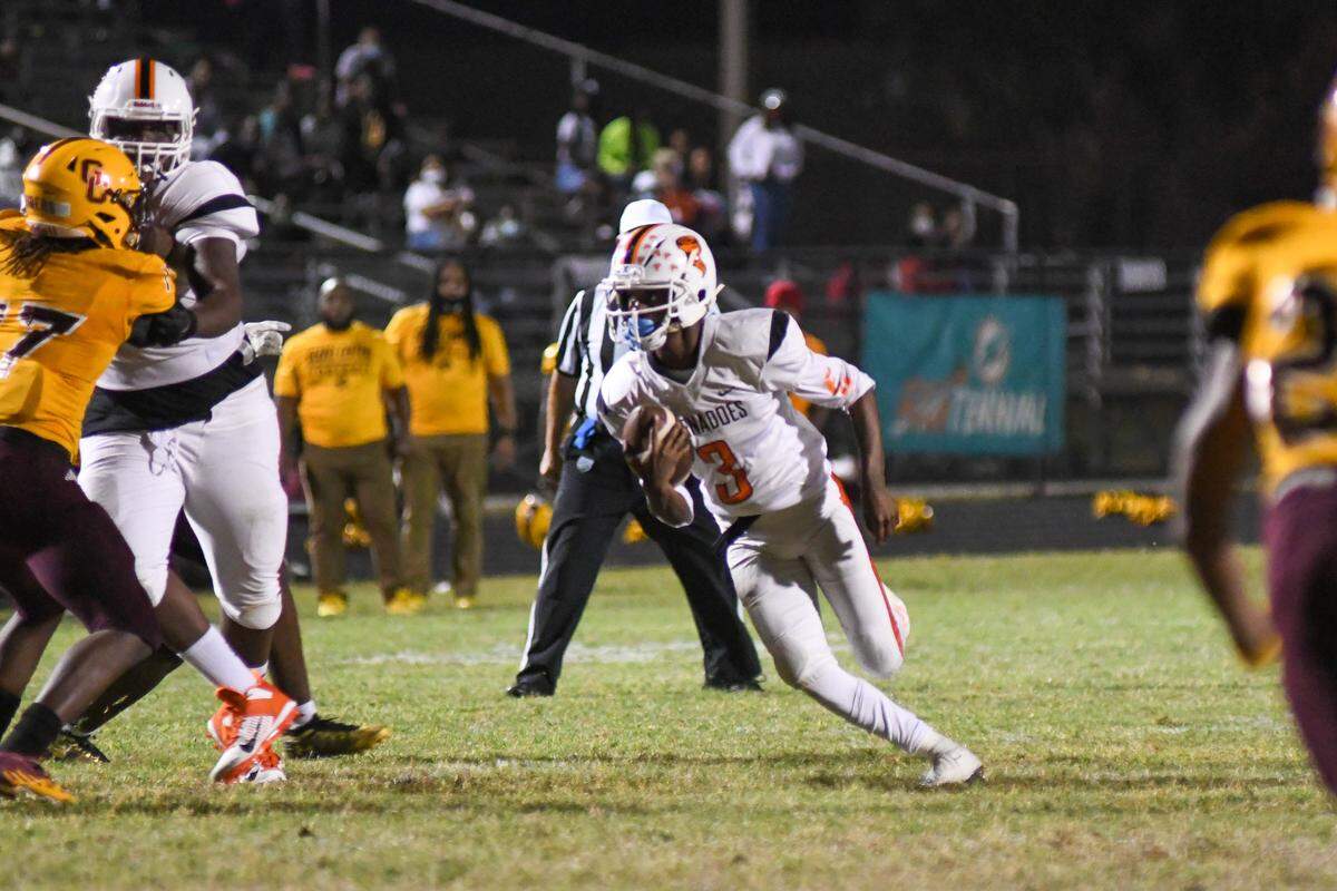 Booker T. Washington quarterback Torrey Morrison scrambles in the first half against Glades Central in a South Florida Tri-County tournament game on Friday, Dec. 4, 2020, in Belle Glade, Florida.