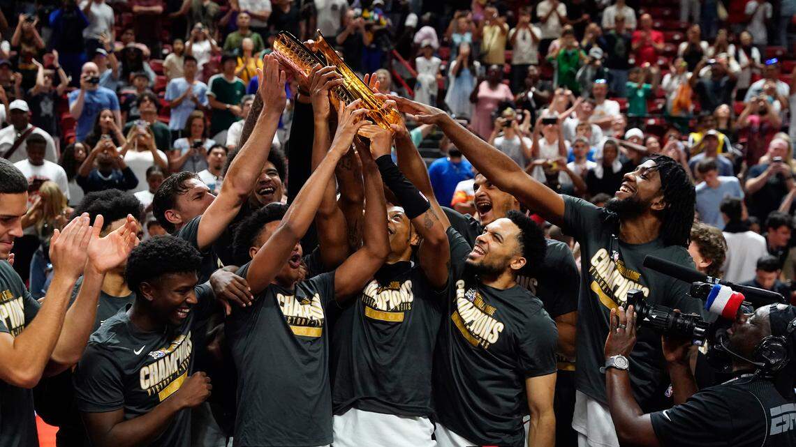 Miami Heat lift the 2025 Summer League Champions trophy after defeating the Memphis Grizzlies in overtime at Thomas & Mack Center.
