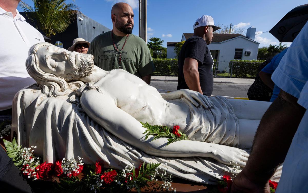 Parishioners carry a statue of Jesus during the Living Stations of the Cross procession near the Cathedral of St. Mary on Friday, April 18, 2025, in Miami, Fla.