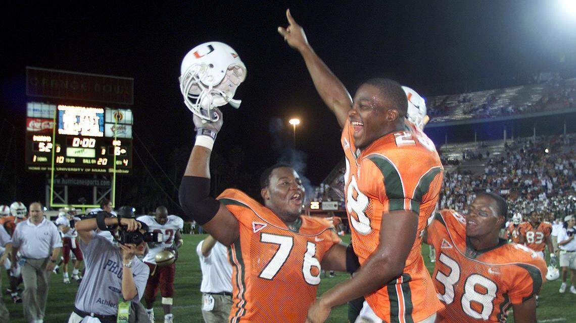FOR SPORTS 11/25/00 PHOTO BY JOE RIMKU JR MHS...The Miami Hurricanes beat Boston College at the Orange Bowl in Miami in 2000 and Carlos Joseph (76) is shown celebrating with Clinton Portis and Carl Walker.