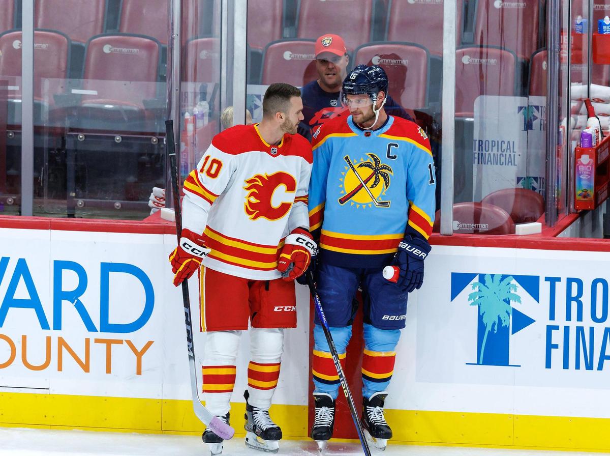 Calgary Flames center Jonathan Huberdeau (10) talks with former teammate Florida Panthers center Aleksander Barkov (16) before the start of an NHL game at FLA Live Arena on Saturday, November 19, 2022 in Sunrise, Fl.