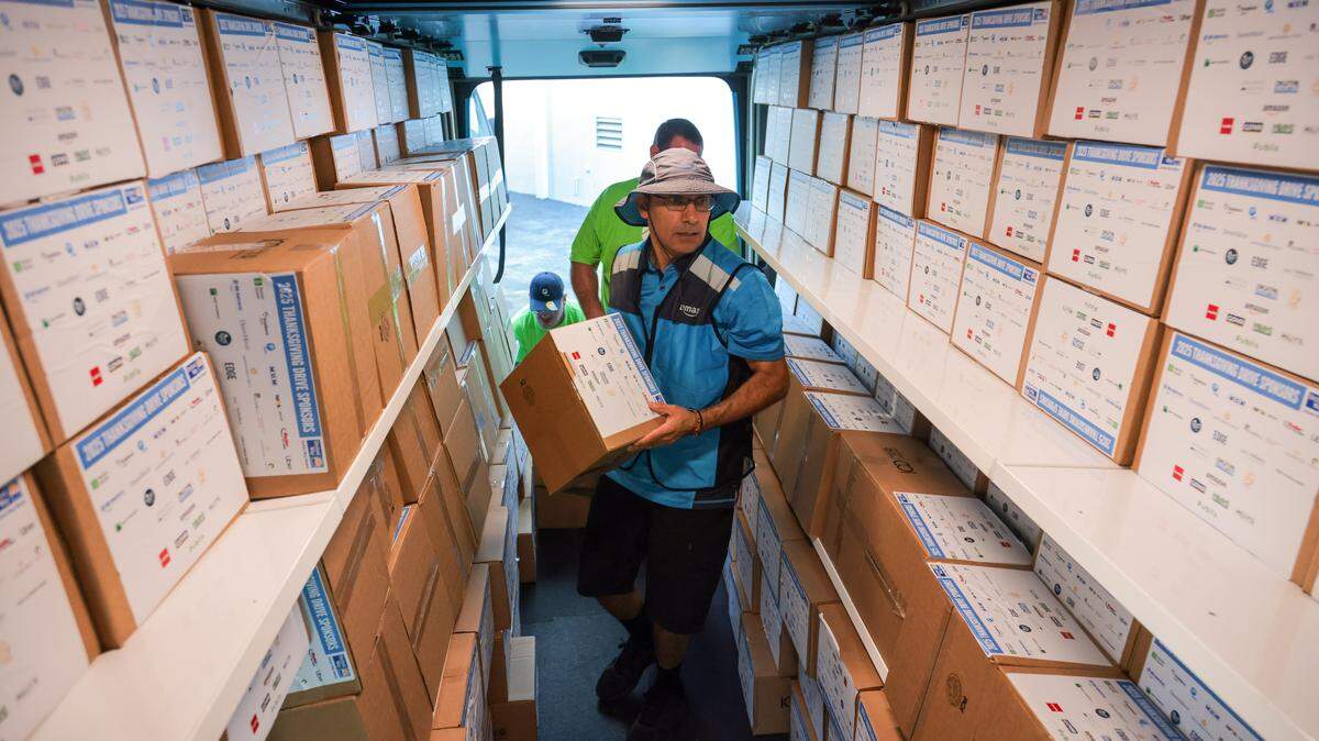 Amazon driver Javier Mendoza loads hundreds of meal boxes into an delivery truck during the United Way Miami annual Thanksgiving Drive at the United Way Ansin Building at 3250 SW 3rd Ave., on Tuesday, Nov. 18, 2025, in Miami, Fla.