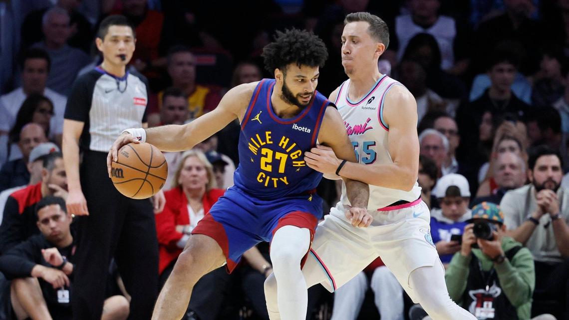 Miami Heat forward Duncan Robinson (55) defends against Denver Nuggets guard Jamal Murray (27) in the first half during their NBA basketball game at the Kaseya Center in Miami, Florida on Friday, January 17, 2025.