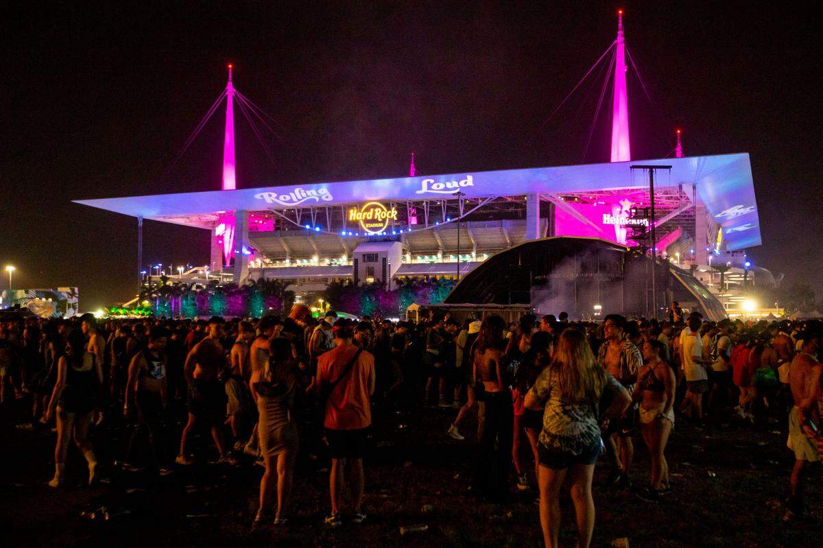 Festival goers exit the venue after artist Kid Cudi left the show early after people throw trash on stage during the first day of Rolling Loud Miami, an international hip-hop festival, at Hard Rock Stadium in Miami Gardens, Florida, on Friday, July 22, 2022.