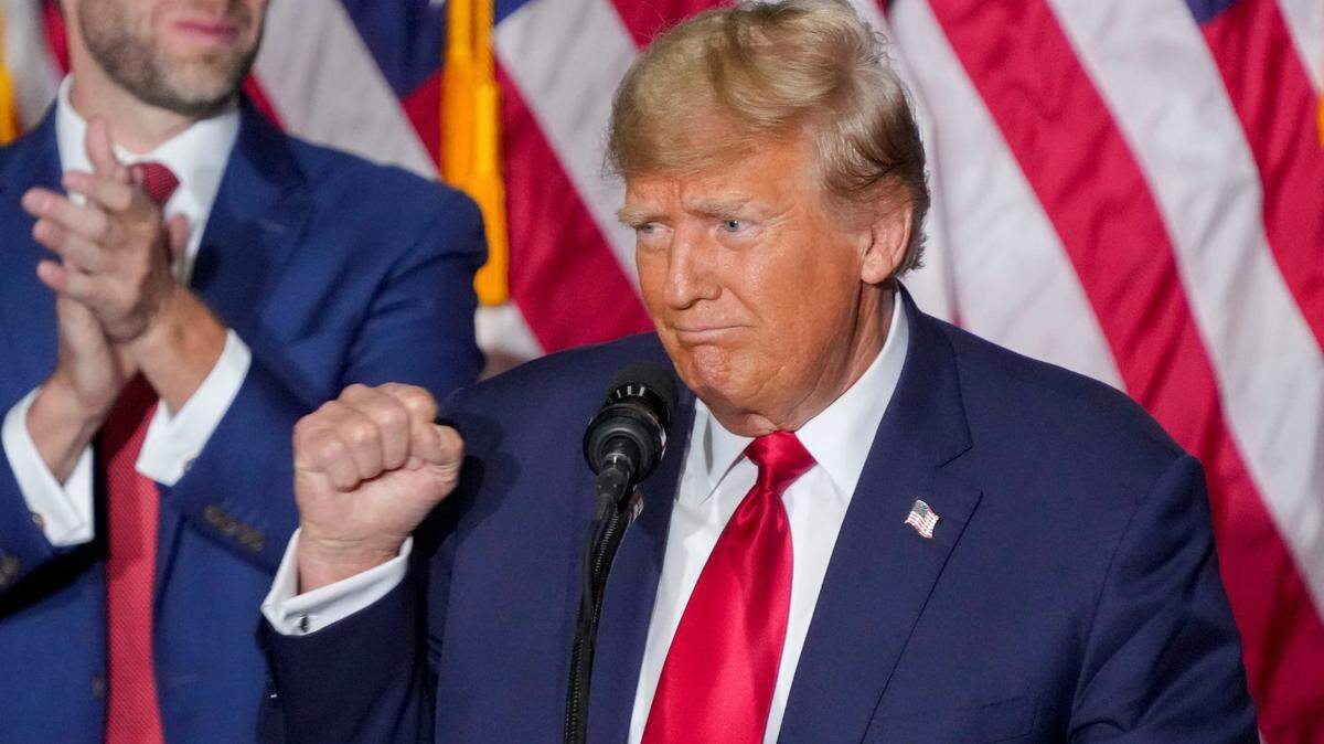 Former President Donald Trump pumps his fist Monday, Jan. 15, 2024, at the Trump caucus night watch party at the Iowa Events Center in Des Moines.