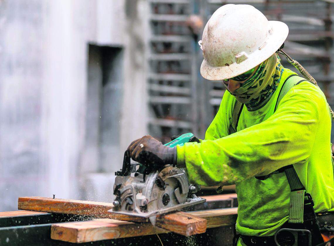Contractors usually complete a floor per week. Above: A worker cuts lumber as construction progress continues inside the 830 Brickell, in Miami, Florida on Friday, September 24, 2021.